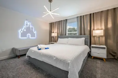 a bedroom with a bed and a castle on the wall at Ultimate Luxury Home-Private Pool Themed Bedroom in Kissimmee