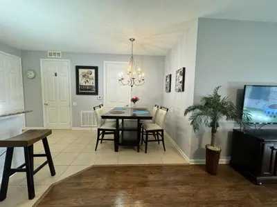 a dining room with a table and chairs and a tv at Vista Cay Hideway Luxury Home By Universal Orlando in Orlando