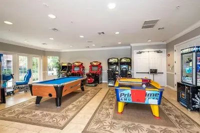 a game room with two pool tables and arcade machines at Vista Cay Hideway Luxury Home By Universal Orlando in Orlando
