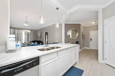 a kitchen with white cabinets and a sink at Orlando Resort: 3BD and electric fireplace in Orlando