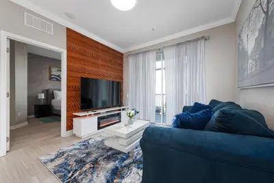 a living room with a blue couch and a television at Orlando Resort: 3BD and electric fireplace in Orlando