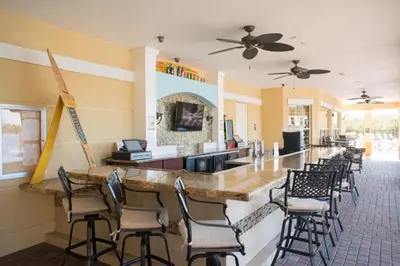 a bar in a restaurant with a row of chairs at Vista Cay Jewel Luxury By Universal Orlando Rental in Orlando