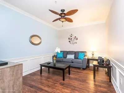 a living room with a couch and a ceiling fan at Vista Cay Jewel Luxury By Universal Orlando Rental in Orlando