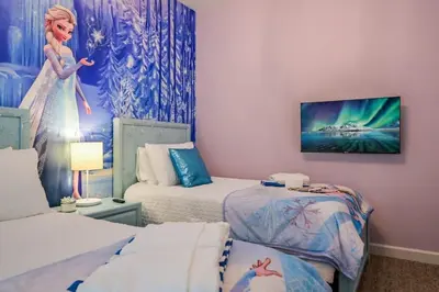 a room with two beds and a painting on the wall at Opulent Retreat Themed Bedrooms and Pool Paradise in Kissimmee