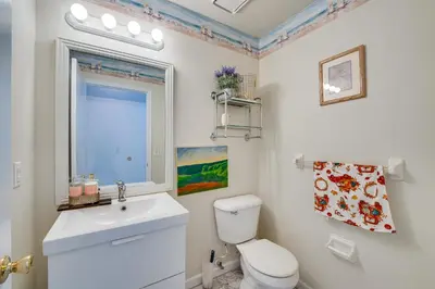 a bathroom with a toilet and a sink and a window at Kissimmee Vacation Rental with Pool about 6 Mi to Disney in Kissimmee