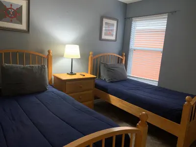a bedroom with two beds and a lamp and a window at Complete Vacation in exclusive 7 Bed resort home, in Kissimmee