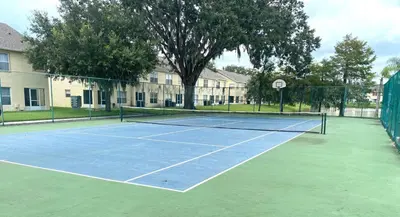 a tennis court in front of a building at Family Friendly Community in Kissimmee