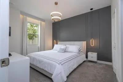 a bedroom with a large white bed and a window at Lakeview 7Br W pool Disney area in Kissimmee