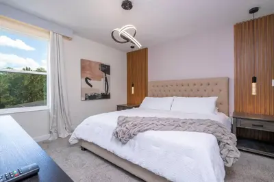 a bedroom with a large bed and a window at Lakeview 7Br W pool Disney area in Kissimmee