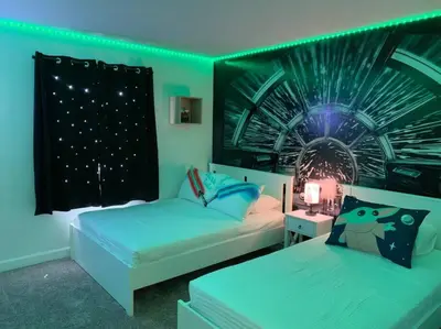 two beds in a room with green lights at BRAND NEW 4BR House Waterpark Disney Orlando 2697 in Kissimmee