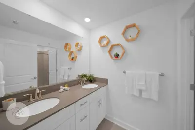 a bathroom with two sinks and a large mirror at BRAND NEW 4BR House Waterpark Disney Orlando 2697 in Kissimmee