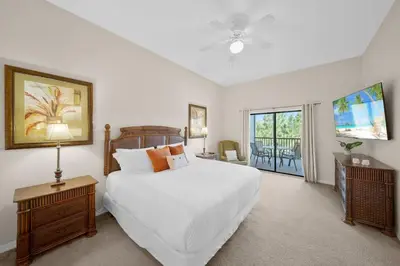 a bedroom with a large white bed and a balcony at Caribe Cove Resort 3BR Condo Apt Disney Orlando in Kissimmee