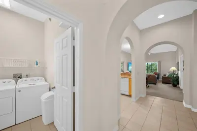 a white laundry room with a washer and dryer at Caribe Cove Resort 3BR Condo Apt Disney Orlando in Kissimmee