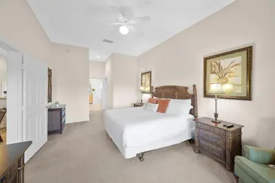 a bedroom with a white bed and a table and a couch at Caribe Cove Resort 3BR Condo Apt Disney Orlando in Kissimmee