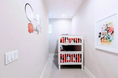 a white room with a white shelf with red shoes at Awesome 4 beds Villa 5 min to Disney in Orlando