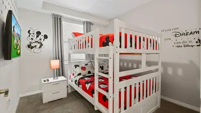 a white bunk bed in a white room with a bed at Beautiful Apartments 5 Minutes away from Disney! in Kissimmee
