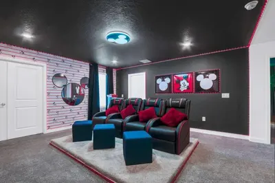a living room with a leather couch and red pillows at Luxury Incredible Themed Home best vacation in Kissimmee