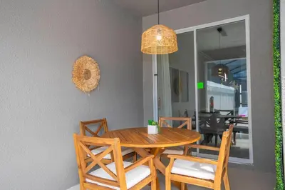 a dining room with a wooden table and chairs at Magnificient 4Bd w Pool @ Storey Lake Resort 2648 in Kissimmee
