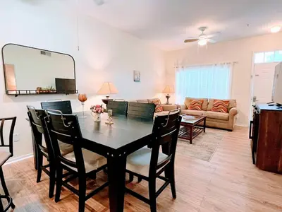 a dining room and living room with a table and chairs at Awesome 3 beds Villa at Seven Dwarfs in Kissimmee