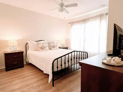 a bedroom with a bed and a dresser and a window at Awesome 3 beds Villa at Seven Dwarfs in Kissimmee