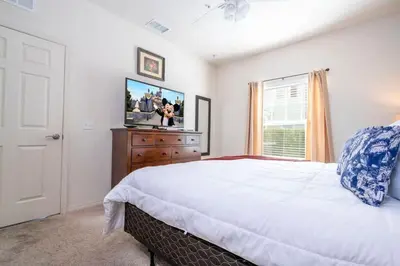 a bedroom with a large bed and a television at Marvelous 4 Bd Close To Disney at West Lucaya 8959 in Kissimmee