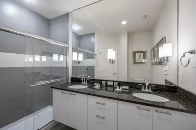 a bathroom with two sinks and a shower at Charming Villa with Private Pool Bliss in Orlando