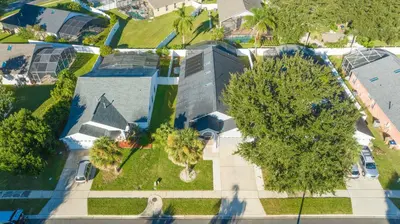an overhead view of a house with a tree at Magical 5-Bedroom Retreat w/ Pool, 3 Ensuite Bedrooms, Near Disney, and Internet! in Kissimmee