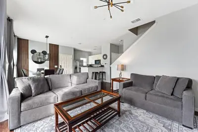 a living room with two couches and a table at Freshly Redesigned 4BR at West Lucaya WL3211 in Kissimmee