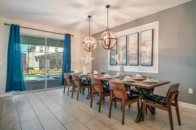 a dining room with a large table and chairs at Family Paradise Space Themed Perfect Location in Kissimmee