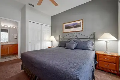 a bedroom with a large bed and a bathroom at Windsor Hills 4BR's Mickeys Ranch Near Disney in Orlando