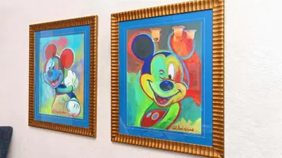 two framed paintings of mickey mouse on a wall at Windsor Hills 4BR's Mickeys Ranch Near Disney in Orlando