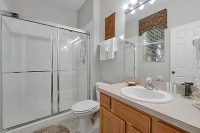 a bathroom with a toilet and a shower and a sink at Windsor Hills 4BR's Mickeys Ranch Near Disney in Orlando