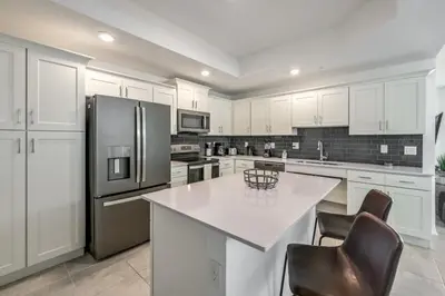a kitchen with white cabinets and a white counter top at Spacious Beautiful 3-BR Condo Prime Location in Kissimmee