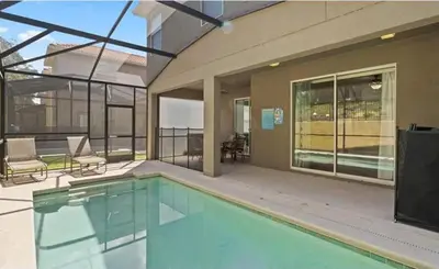 a swimming pool in front of a building at 8931 Cuban Palm in Kissimmee
