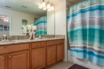a bathroom with two sinks and a large mirror at 3071 Beach Palm in Kissimmee