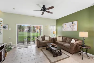 a living room with a couch and a ceiling fan at 8538 Crystal Cove in Kissimmee
