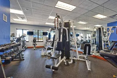 a gym with several treadmills and machines at Beautiful 4 beds at Paradise Palms Resort in Kissimmee