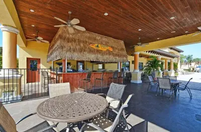 a patio with a table and chairs and a bar at Beautiful 4 beds at Paradise Palms Resort in Kissimmee