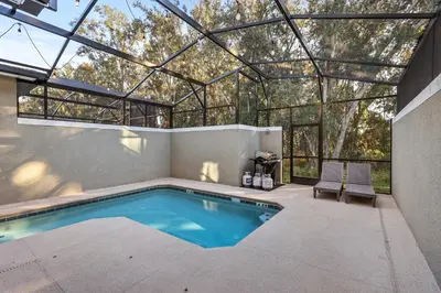 a swimming pool in a house with a glass roof at House with pool in resort in Kissimmee