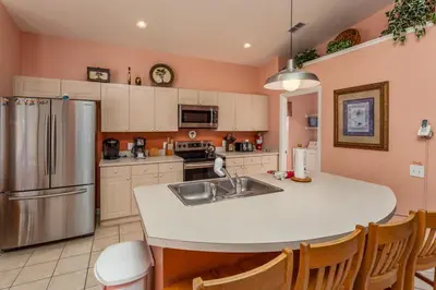 a kitchen with a sink and a refrigerator at 2217 Wyndham Palms in Kissimmee