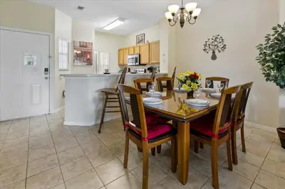a kitchen and dining room with a table and chairs at 8569 Crystal Cove in Kissimmee