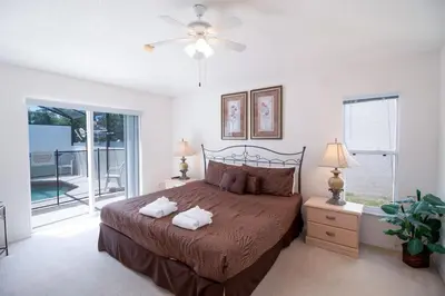 a bedroom with a bed and a ceiling fan at Private Pool Home at Seasons Community in Kissimmee