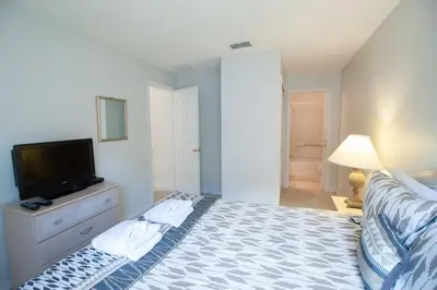 a bedroom with a bed and a flat screen tv at Private Pool Home at Seasons Community in Kissimmee