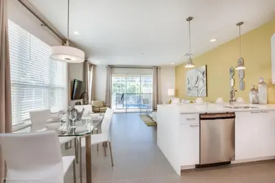a kitchen and dining room with a table and chairs at Luxury Retreat with Pool in Orlando