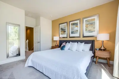a bedroom with a large white bed and two windows at Luxury Retreat with Pool in Orlando