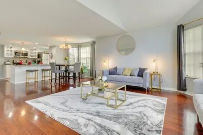 a living room with a couch and a table at Kissimmee Condo with Perks 6 Mi to Disney World! in Kissimmee