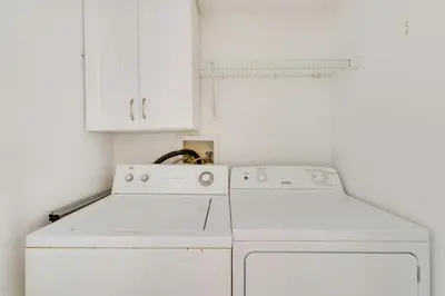 a kitchen with white appliances and white cabinets at Kissimmee Condo with Perks 6 Mi to Disney World! in Kissimmee
