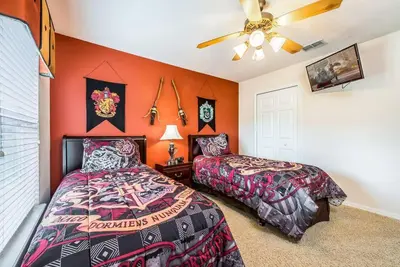 a bedroom with two beds and a ceiling fan at Enchanted Villa Oasis in Orlando