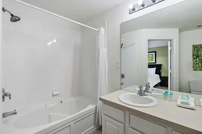 a bathroom with a white tub and a sink and a bath tub at 2563 Maneshaw in Orlando