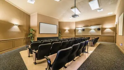 a conference room with chairs and a screen at 2563 Maneshaw in Orlando